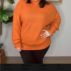 Oversized burnt orange roll neck and roll sleeve sweater.